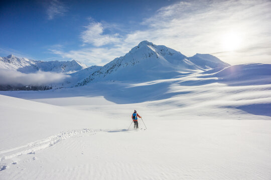 Backcountry skier making turns on the Spearhead Traverse, Whistler.