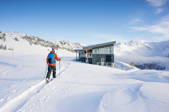 Backcountry skier approaches Kees and Claire Hut, Whistler B.C.