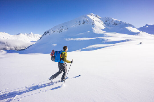 Side view of man ski touring in the Whistler backcountry