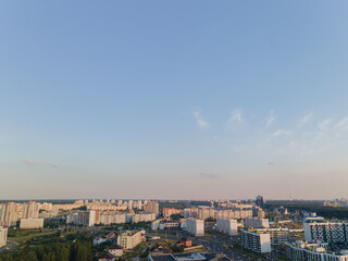Obraz premium Top view of the city, landscape and buildings, sky and silhouettes of houses from the height of a flying drone. 