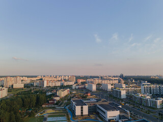 Obraz premium Top view of the city, landscape and buildings, sky and silhouettes of houses from the height of a flying drone. 