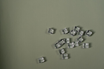 Blank paper  mockup copy space and ice cubes on a green olive background. minimalistic aesthetic template. Flat lay, top view