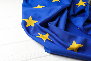 Flag of European Union on white wooden table, closeup