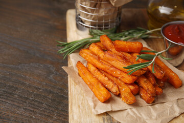 Sweet potato fries and rosemary on wooden table, closeup