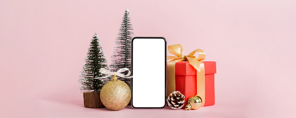 Digital phone mock up with rustic Christmas decorations for app presentation with empty space for you design. Christmas online shopping concept. Tablet with copy space on colored background