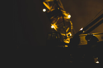 Big boom crane with light lights in the dark