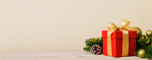 New Year Christmas mood, gift box, branches of a christmas tree, New Year decorations on a colored...