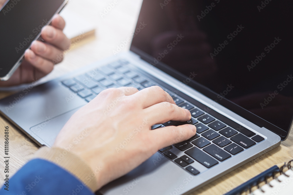 Poster with an office setting blurred in the background, the image presents a close-up of male hands typing