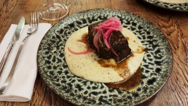 Galician beef cheek ingot with potato parmentier at the restaurant in Barcelona.