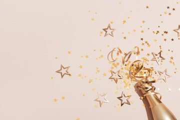 Party background with champagne and golden confetti stars. Christmas, birthday or wedding concept....