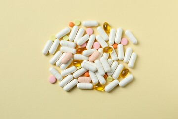 Various pills and capsules on a color background