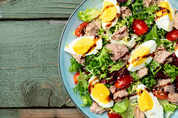 Canned Tuna salad with eggs and tomatoes photography . Top view