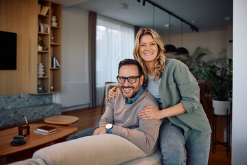 Portrait of happy couple at home looking at camera.