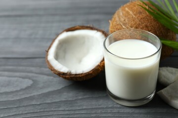 Glass of coconut milk on wooden background 