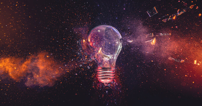 Glass shards and fire exploding from broken lightbulb