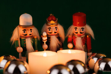 Classic Wooden Nutcracker with Original Hair and Candles on a Deep Green Canvas with Holiday...