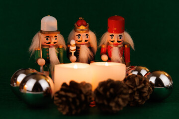 Joyful Nutcracker with Original Hair and Lit Candles Next to Holiday Decorations on a Cheerful Green Background