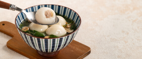 Eating big tangyuan yuanxiao with savory soup in Taiwan.