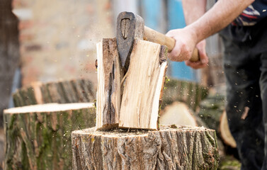 a man chops  wood