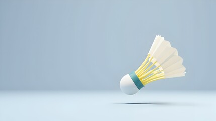 A single shuttlecock, poised mid-flight, against a serene, light-blue backdrop.  Its yellow and white feathers catch the unseen light, promising an exciting badminton match.