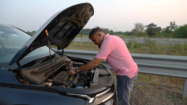 Stressed Indian man anxious driver talk mobile phone in city breakdown car with open bonnet background road accident broken auto automobile