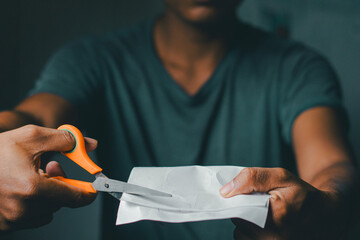 Man cutting paper with scissors, close-up