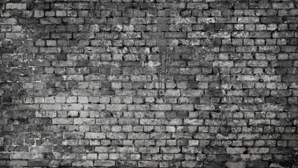 The photo shows a close-up of a grey brick wall