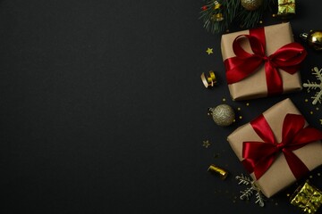 Beautiful gift boxes tied with bows and Christmas decorations on black background 