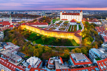 Aerial view of the beautifully illuminated Bratislava Castle after an autumn sunset