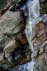 Rushing waterfall cascades through rocky terrain serene forest nature photography tranquil setting close-up perspective natural beauty