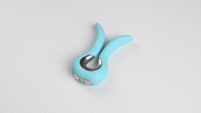 Blue vibrator spinning on white background. 