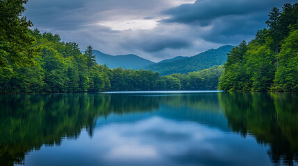 Serene mountain lake surrounded by lush forests and rolling hills