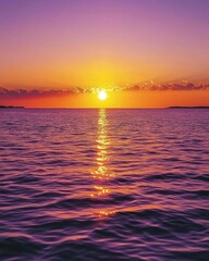 Obraz premium A serene sunset over calm waters, reflecting vibrant colors.