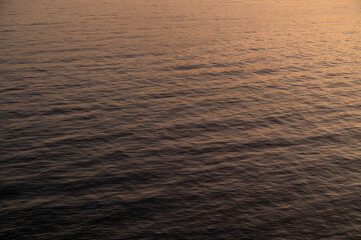 Water sea sunset. Sun reflection ocean waves. Nature golden abstract texture surface.