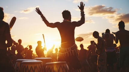 Fototapeta premium Silhouetted man dances at sunset, vibrant crowd enjoys music and drums.