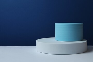 White podiums on color background 