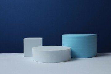 White podiums on color background 