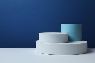 White podiums on color background 