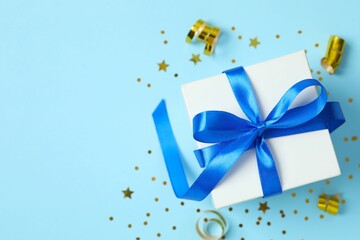Beautiful gift box tied with bow on color background 