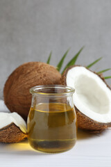 Jar of coconut oil on wooden background