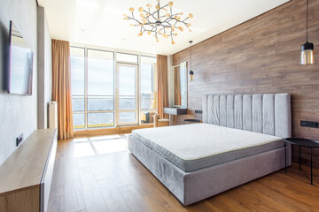 large modern bedroom bed with headboard warm wooden laminate on wall