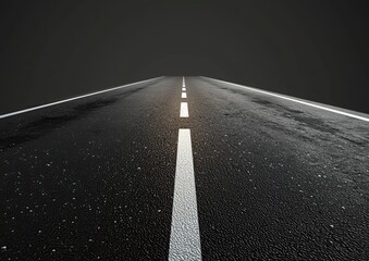 A long highway stretches into the distance with clear white lines on a freshly paved asphalt surface under a dark sky