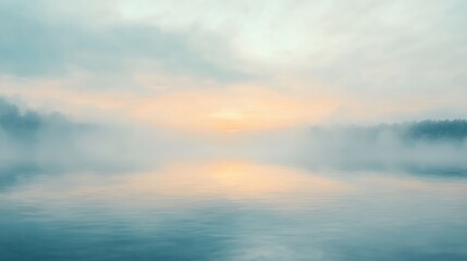 Misty sunrise over calm, foggy water.