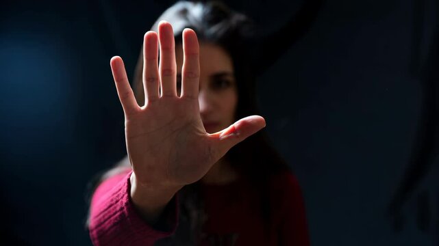 Stop violence against women, stop woman abuse. Woman with raised hand for dissuade