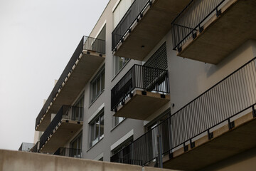 A large and modern building that features numerous balconies and an abundance of windows, making it...