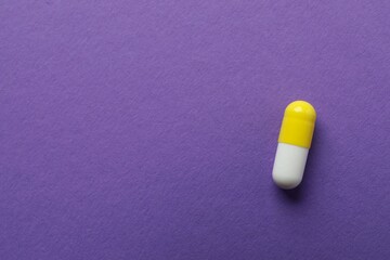 Medicine capsule on color background