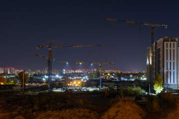 Cranes Over the City: Nighttime Activity in Real Estate Development