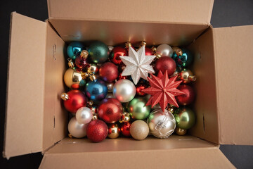 Cardboard box filled with Christmas decorations contents showcased