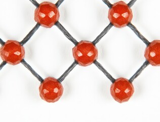 Obraz premium Close-Up View of a Patterned Textile with Red Beads and Black Thread, Showcasing Intricate Design Elements for Decorative Purposes
