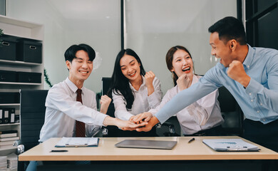 Group of business workers standing with hands together at the office